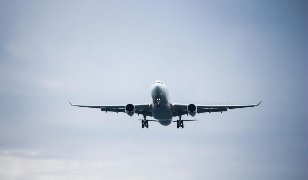 A commercial airplane captured flying, providing a sense of movement and freedom.